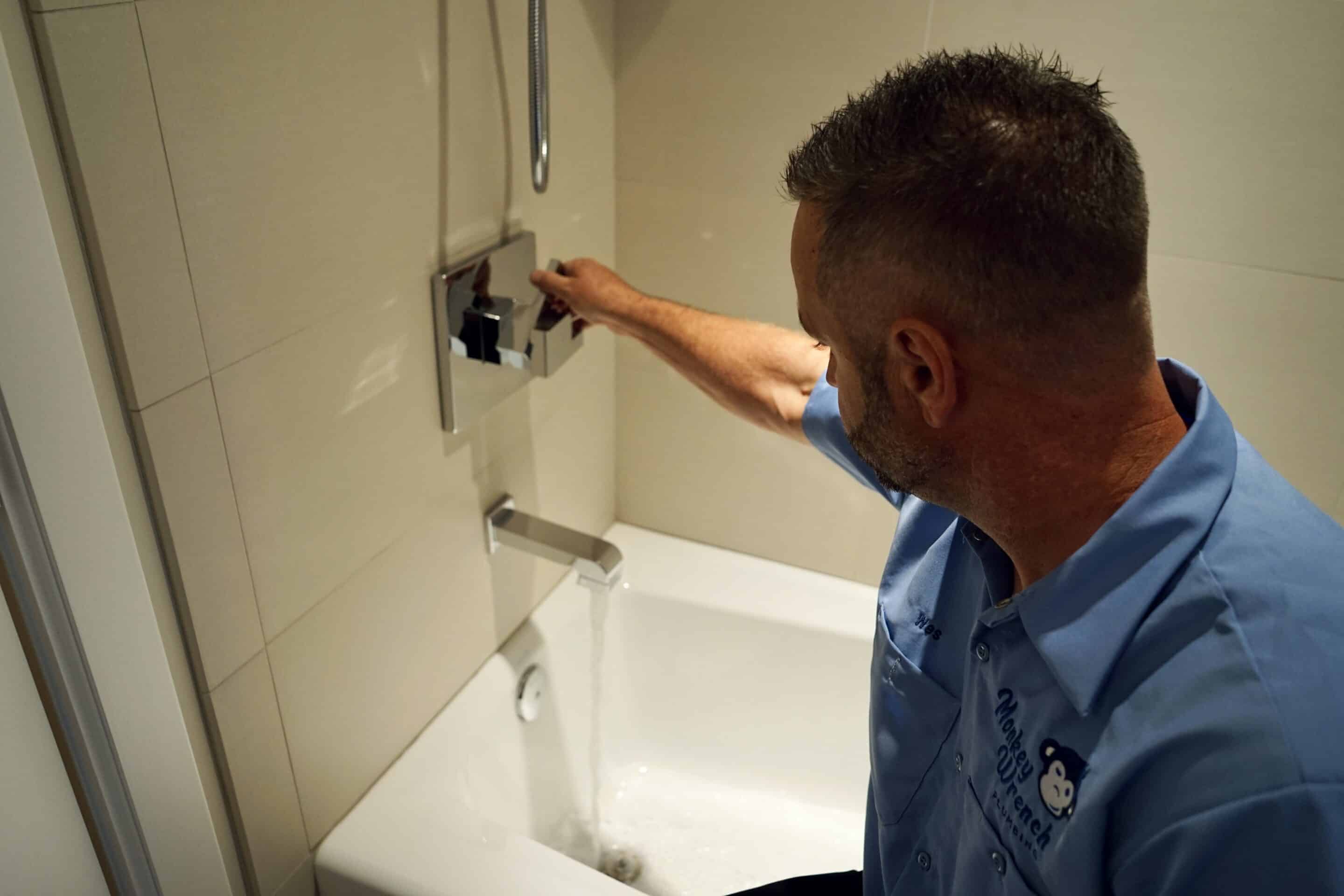 Monkey Wrench Plumber Inspecting a Shower Drain | Plumbing Services in South Jordan | Expert Plumber in South Jordan